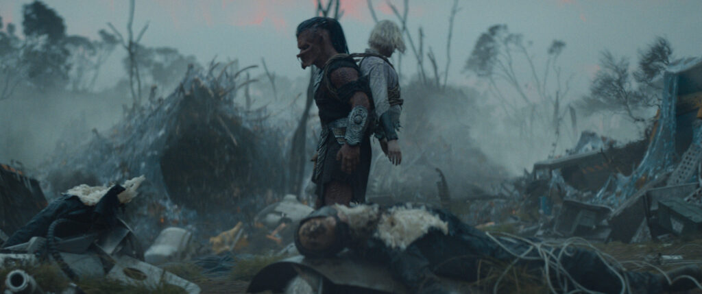 Dimitrius Schuster-Koloamatangi and Elle Fanning in Predator: Badlands