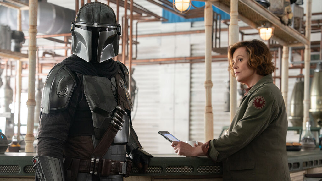 A scene from The Mandalorian and Grogu, with Mando and Sigourney Weaver