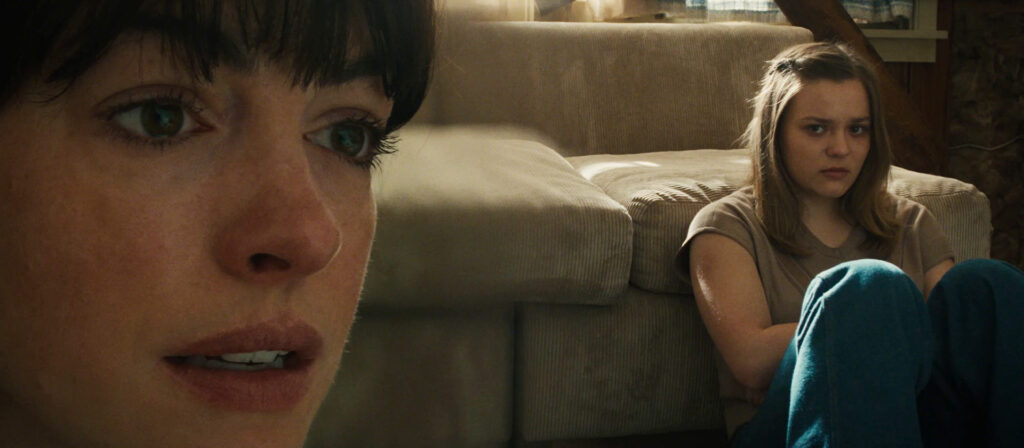 Anne Hathaway, and Maisy Stella in a split diopter shot in The End of Oak Street