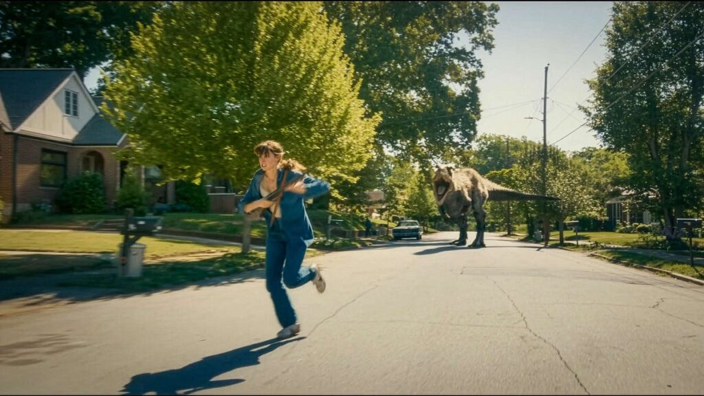 Anne Hathaway running from a dinosaur in The End of Oak Street